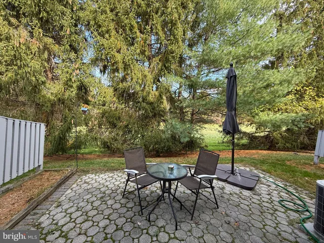a view of a yard with furniture and garden