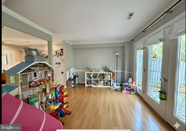 a living room filled with furniture and a wooden floor