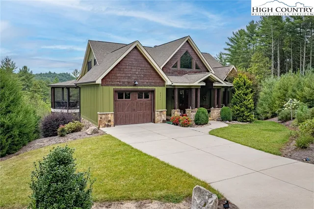a living room filled with furniture and a large window