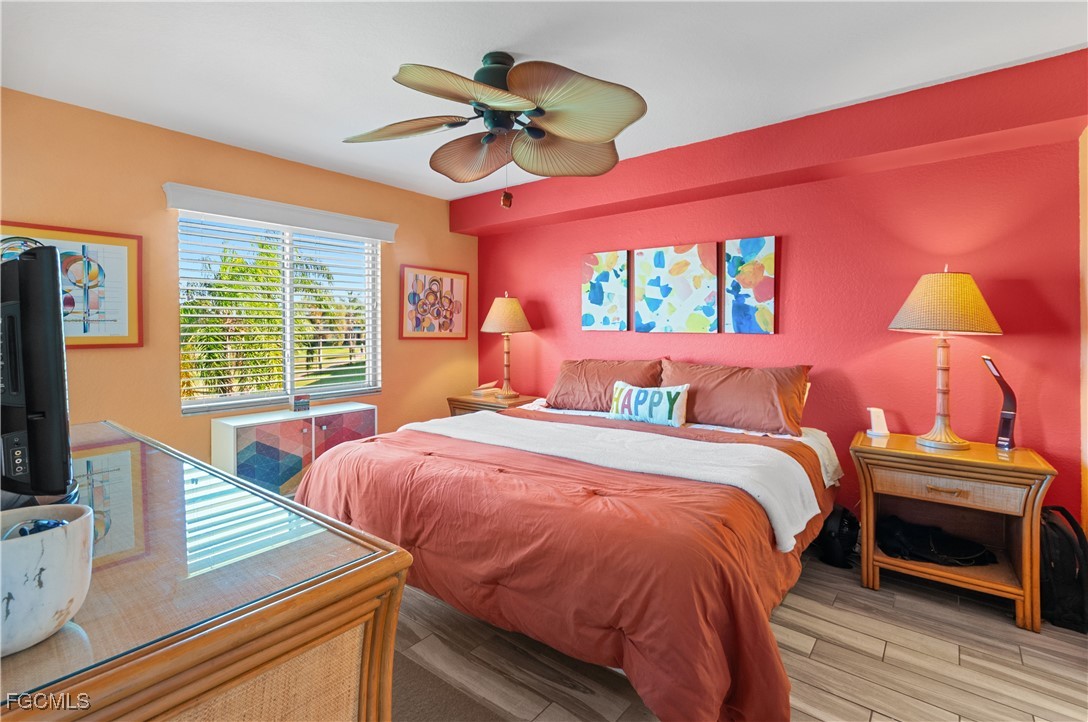 20121 Ian Court, Unit 209 Estero, FL 33928 - Photo 12 of 40 a bedroom with a bed and a flat screen tv