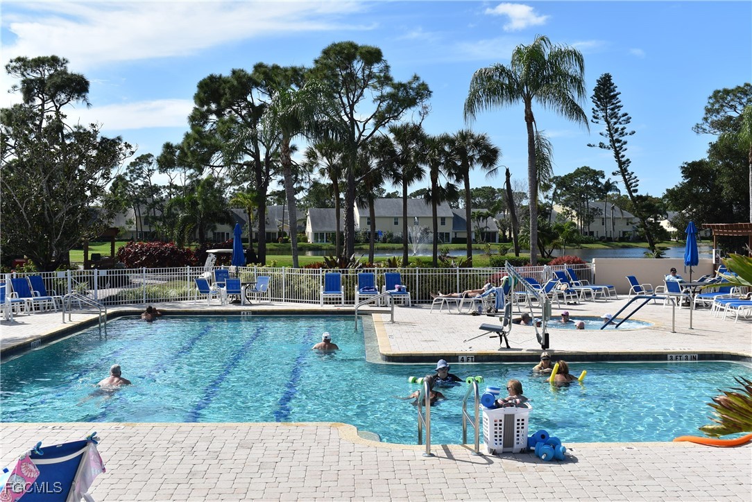 20121 Ian Court, Unit 209 Estero, FL 33928 - Photo 29 of 40 a view of a swimming pool and lounge chairs