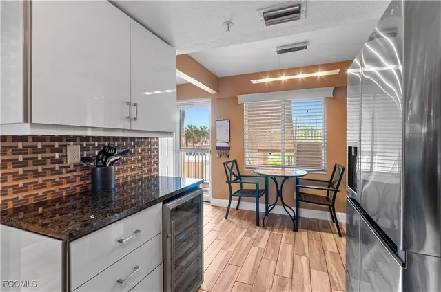 a kitchen with stainless steel appliances granite countertop sink stove top oven and cabinets
