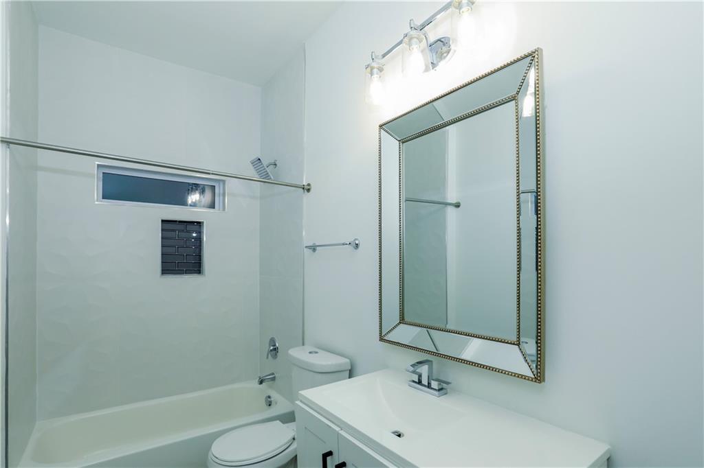 3040 Valley Circle Decatur, GA 30033 - Photo 17 of 19 a bathroom with a sink and mirror with bathtub