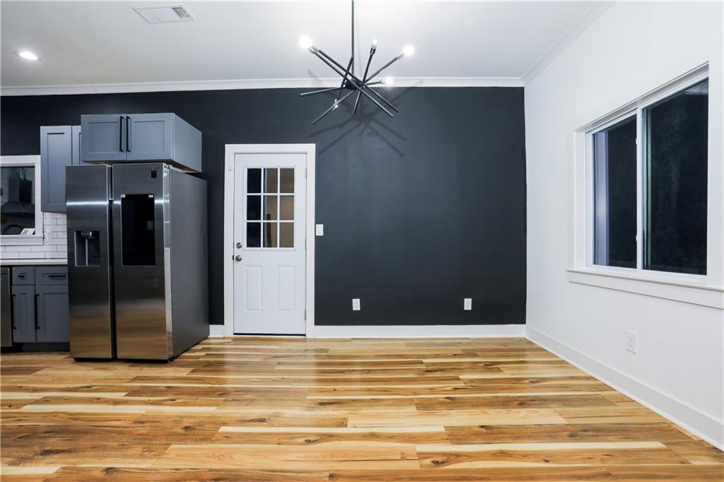 3040 Valley Circle Decatur, GA 30033 - Photo 4 of 19 a view of a livingroom with a dinning area hardwood floor and a ceiling fan