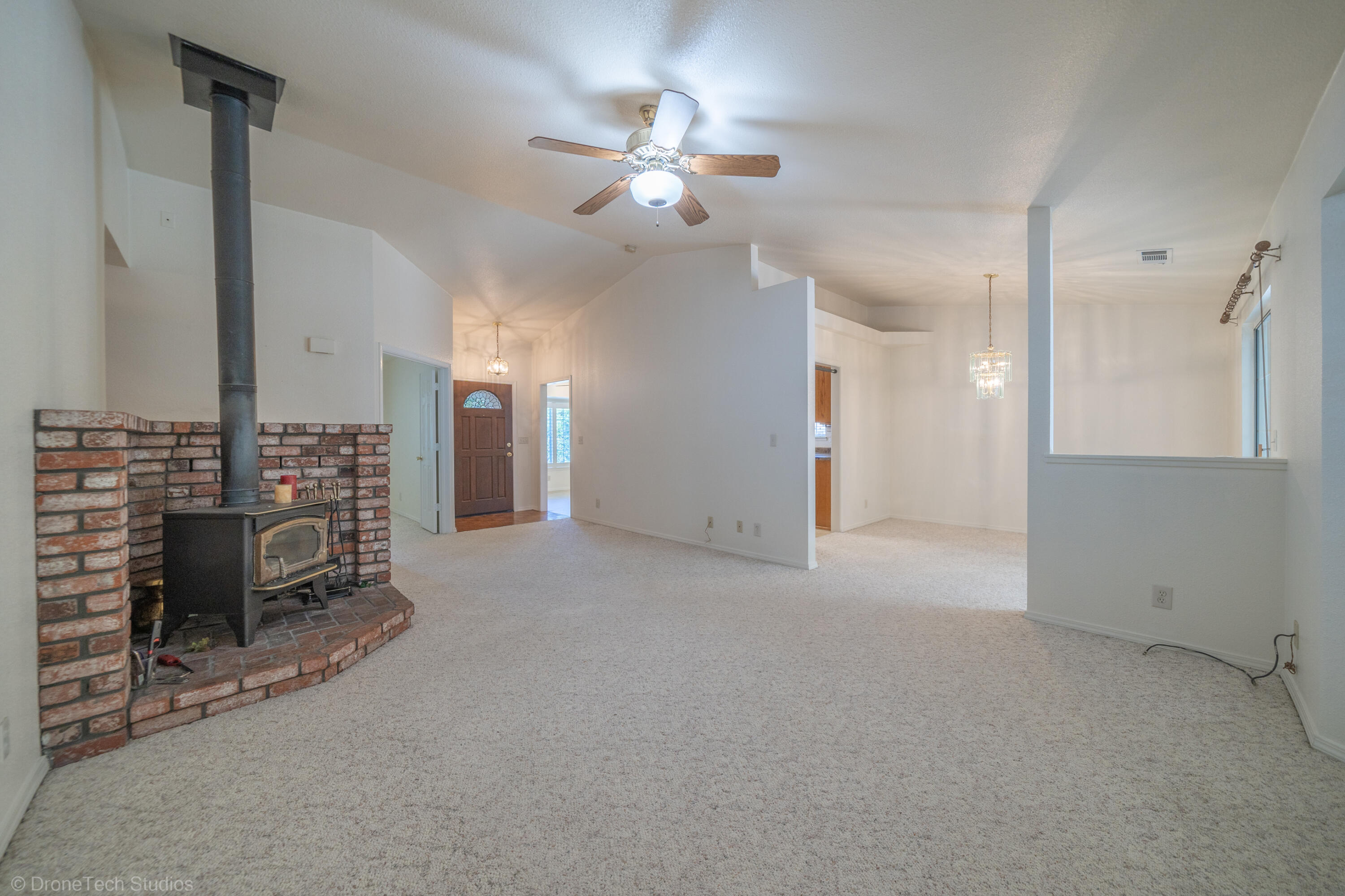 2227 Wicklow Street Redding, CA 96001 - Photo 13 of 90 an empty room with chandelier fan and windows