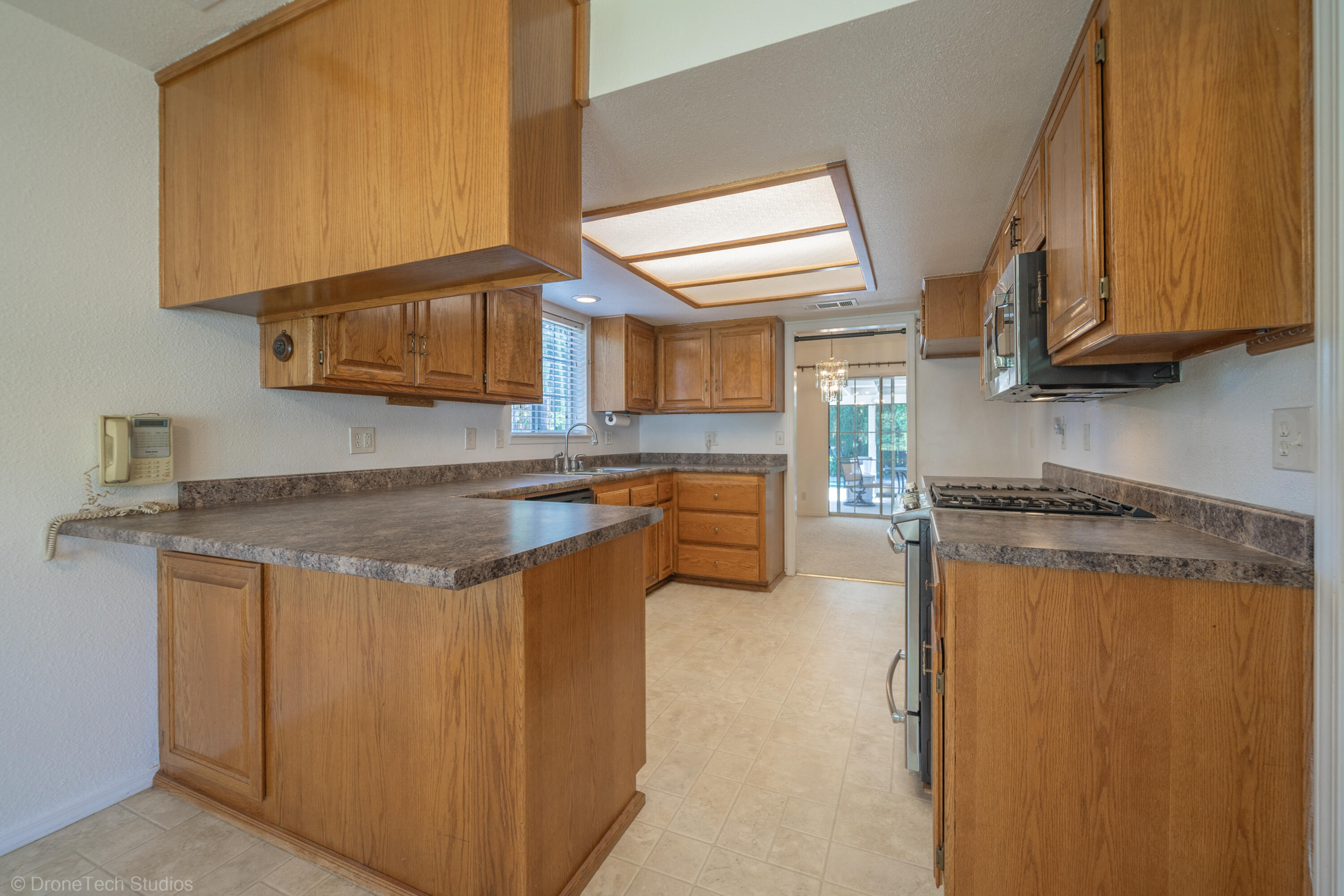 2227 Wicklow Street Redding, CA 96001 - Photo 18 of 90 a kitchen with stainless steel appliances granite countertop a stove a sink and a refrigerator