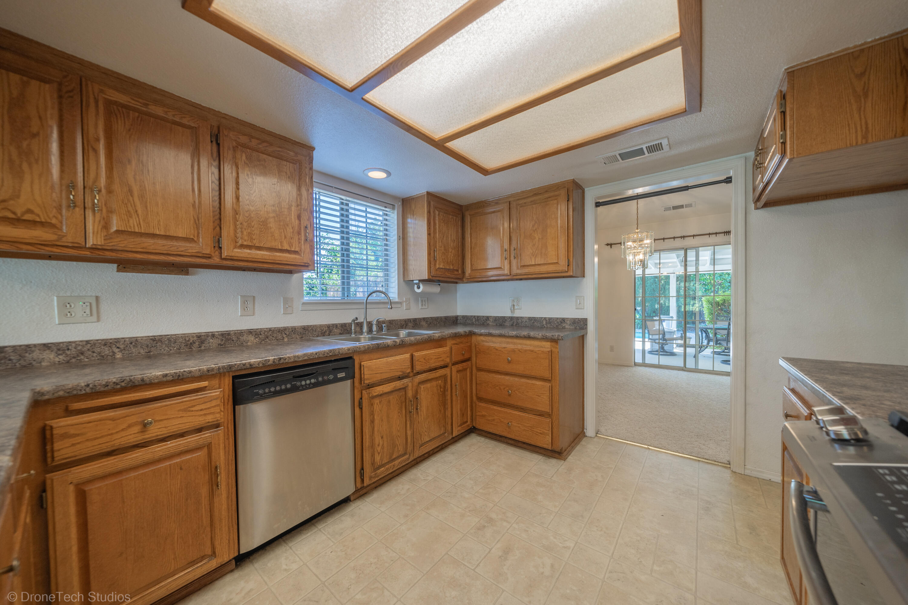 2227 Wicklow Street Redding, CA 96001 - Photo 19 of 90 a kitchen with granite countertop cabinets stainless steel appliances a sink and a window