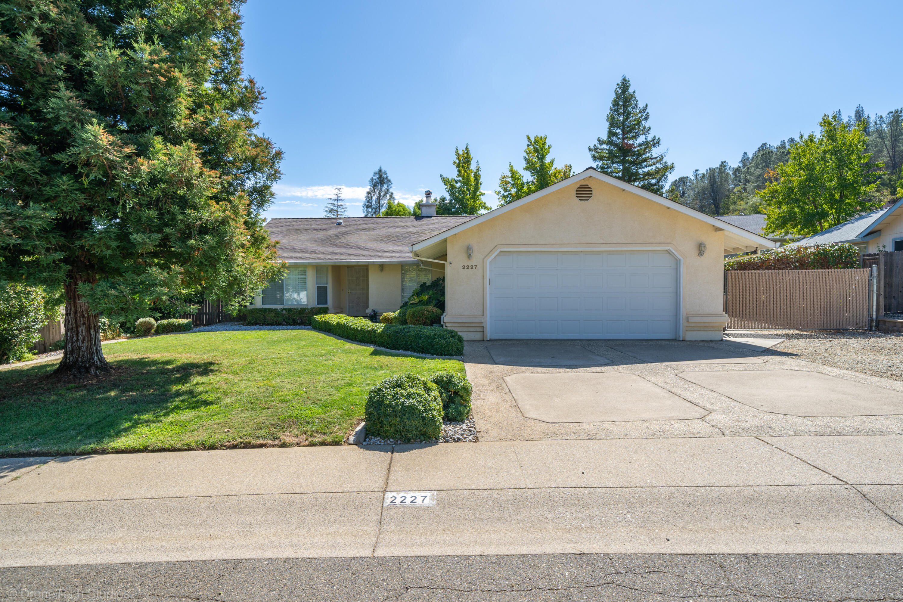 2227 Wicklow Street Redding, CA 96001 - Photo 2 of 90 a front view of a house with a yard and a garage