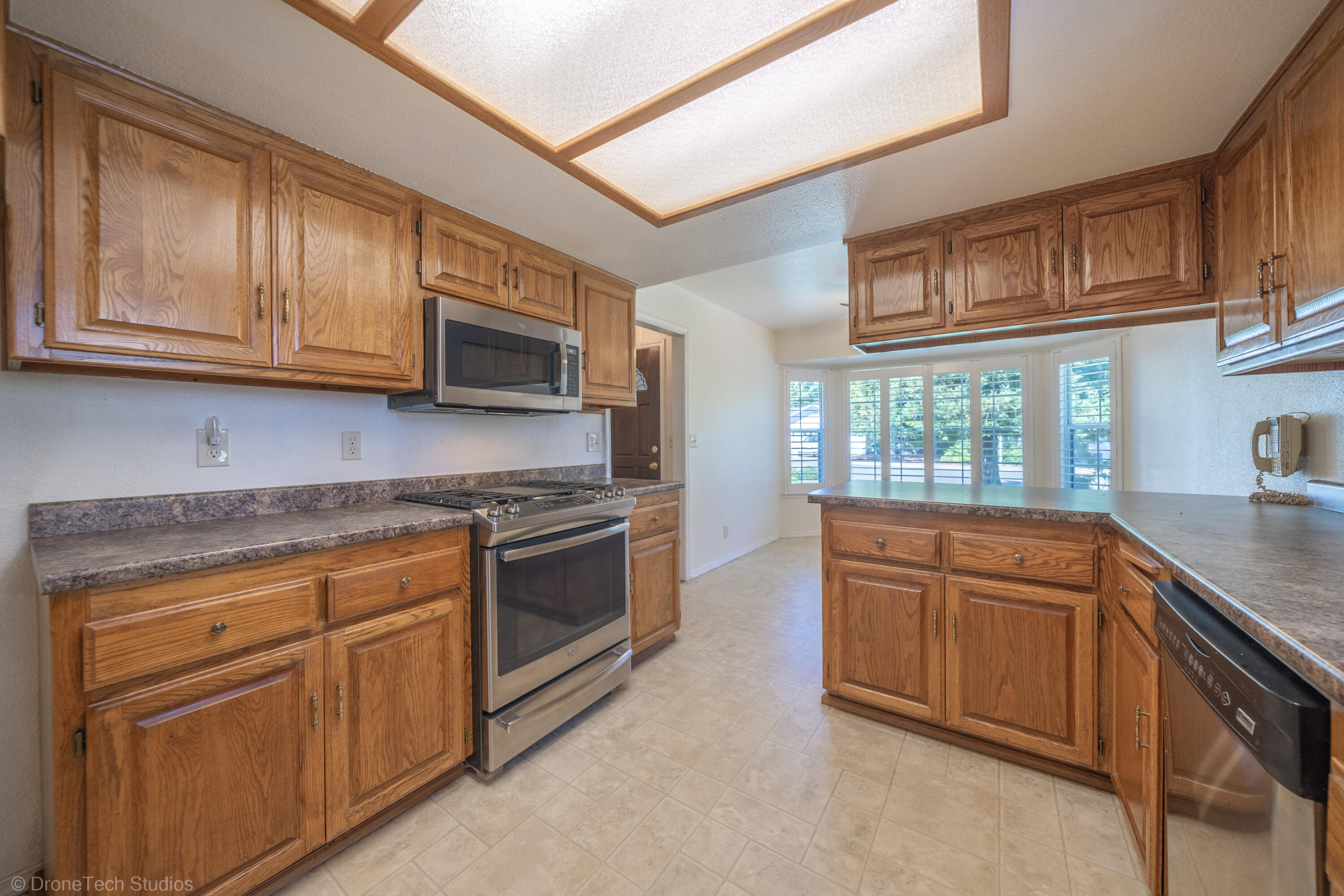 2227 Wicklow Street Redding, CA 96001 - Photo 21 of 90 a kitchen with stainless steel appliances granite countertop a stove microwave and cabinets