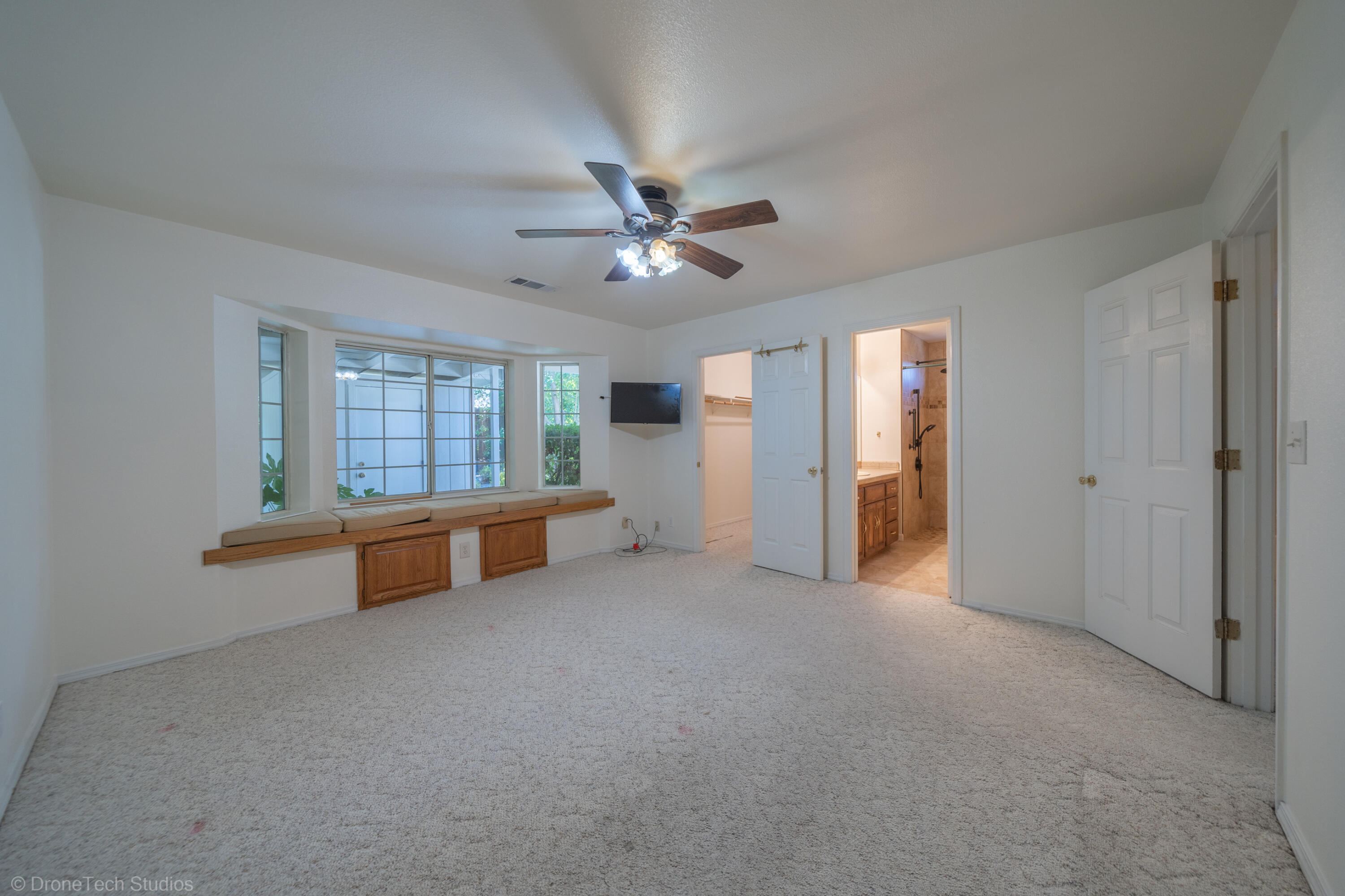 2227 Wicklow Street Redding, CA 96001 - Photo 24 of 90 an empty room with windows and ceiling fan