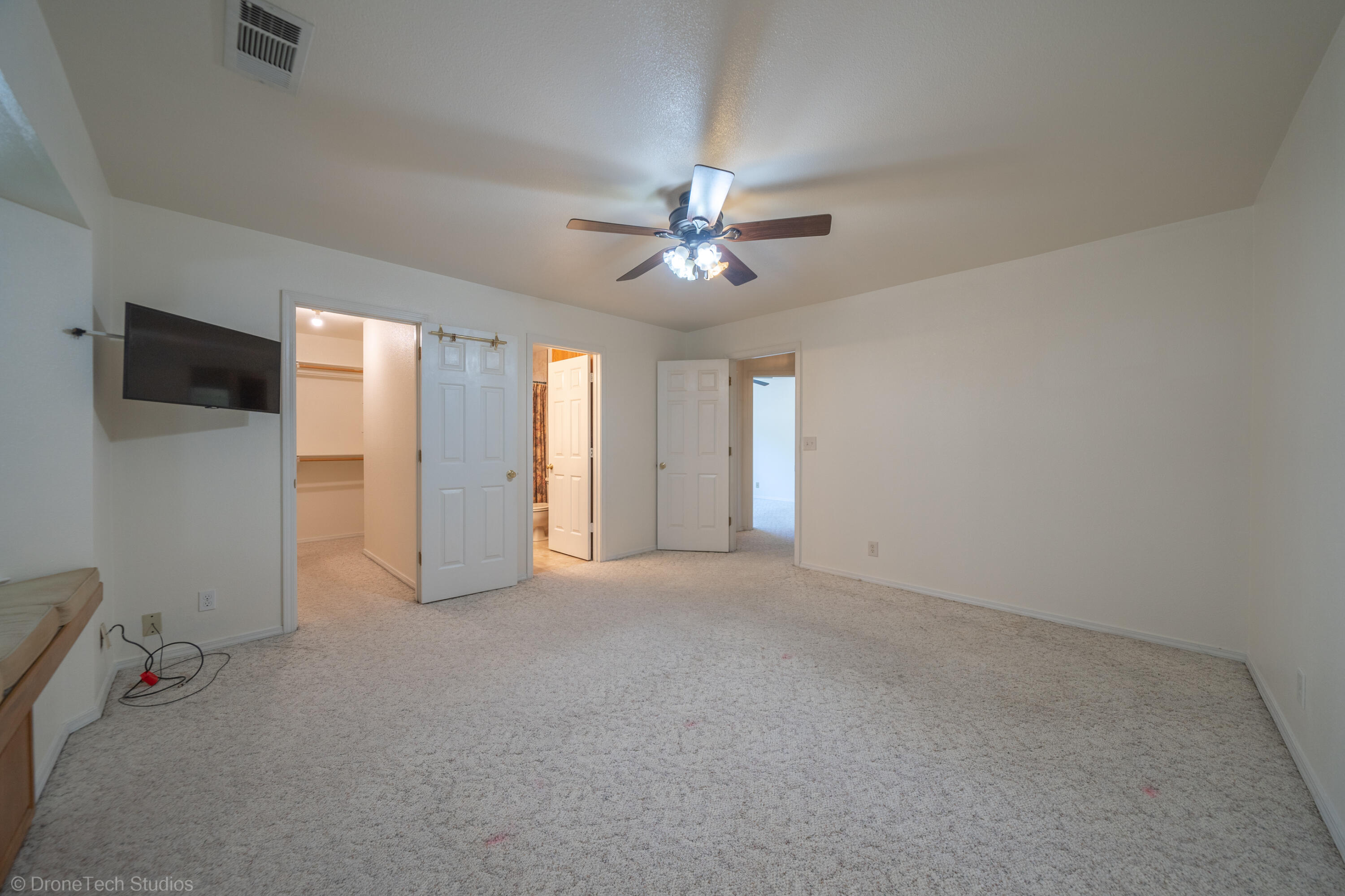 2227 Wicklow Street Redding, CA 96001 - Photo 25 of 90 an empty room with chandelier fan and windows
