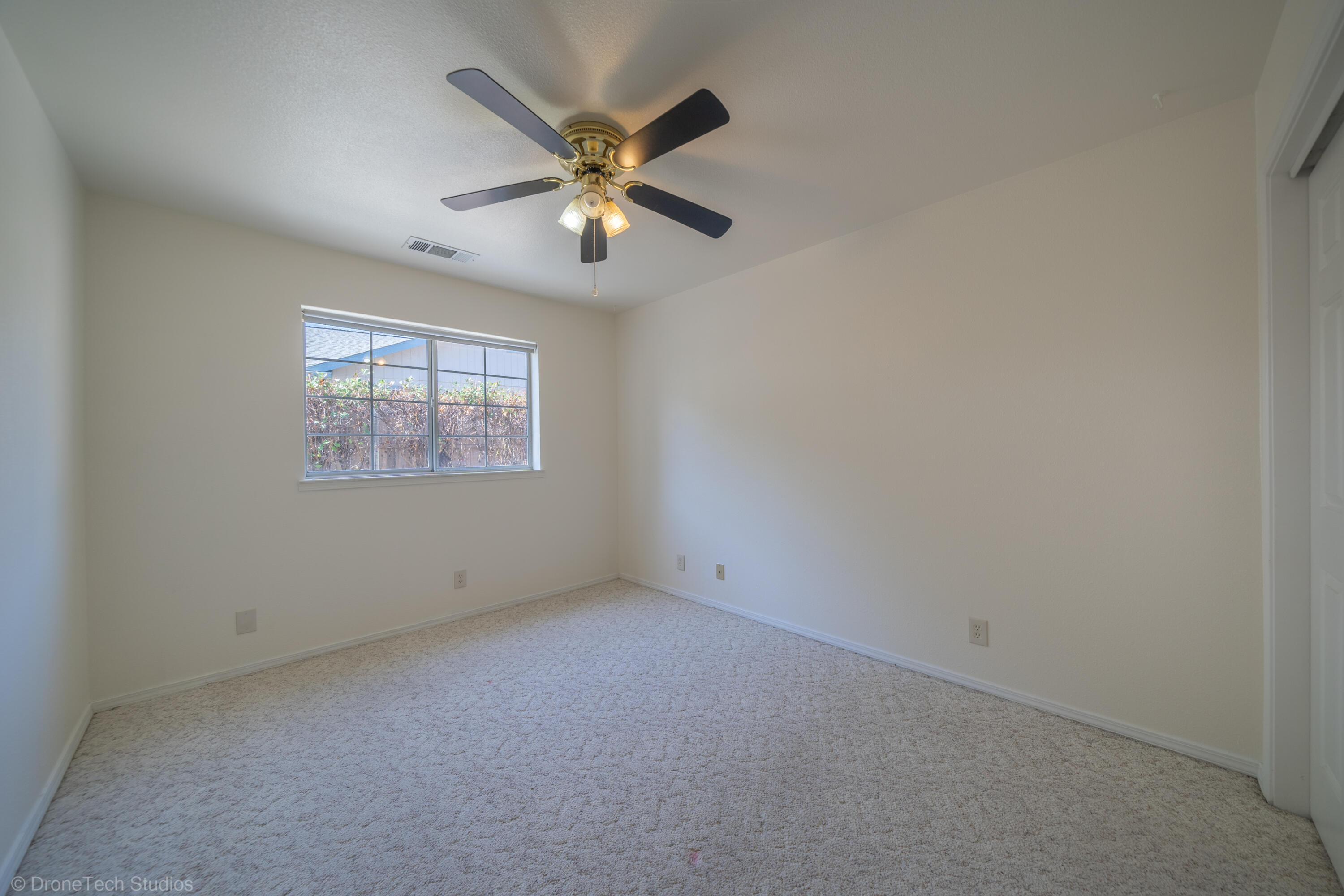 2227 Wicklow Street Redding, CA 96001 - Photo 29 of 90 an empty room with windows and fan