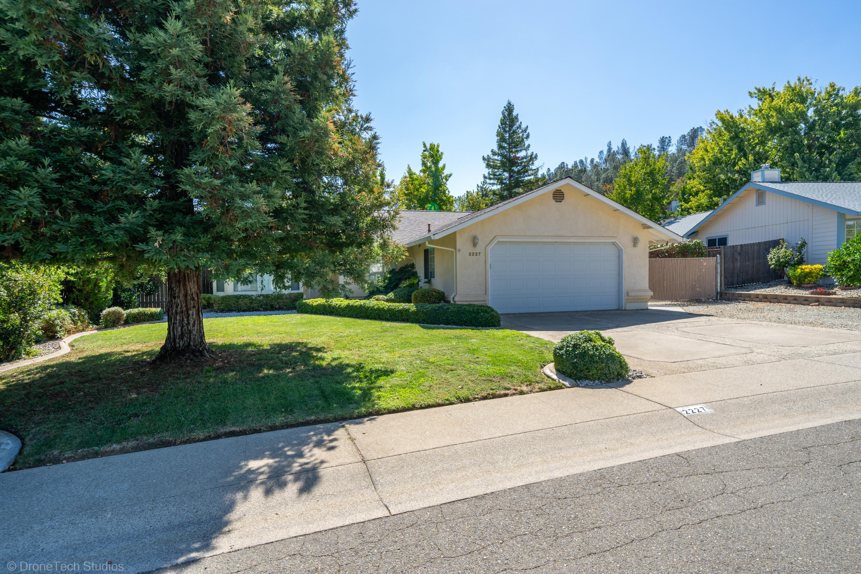 2227 Wicklow Street Redding, CA 96001 - Photo 3 of 90 a front view of a house with a garden and yard