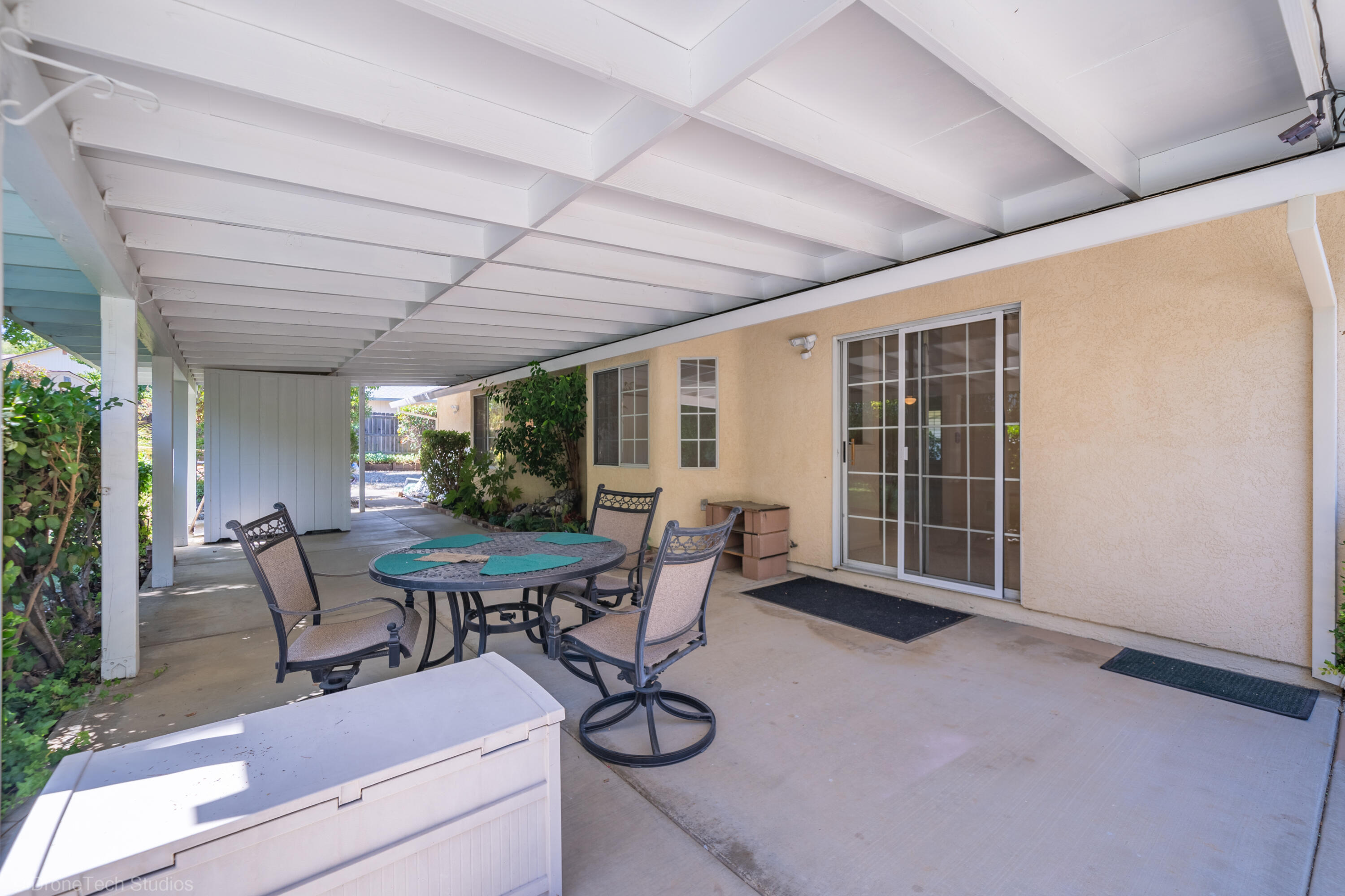 2227 Wicklow Street Redding, CA 96001 - Photo 38 of 90 a view of a patio with a table and chairs and potted plants