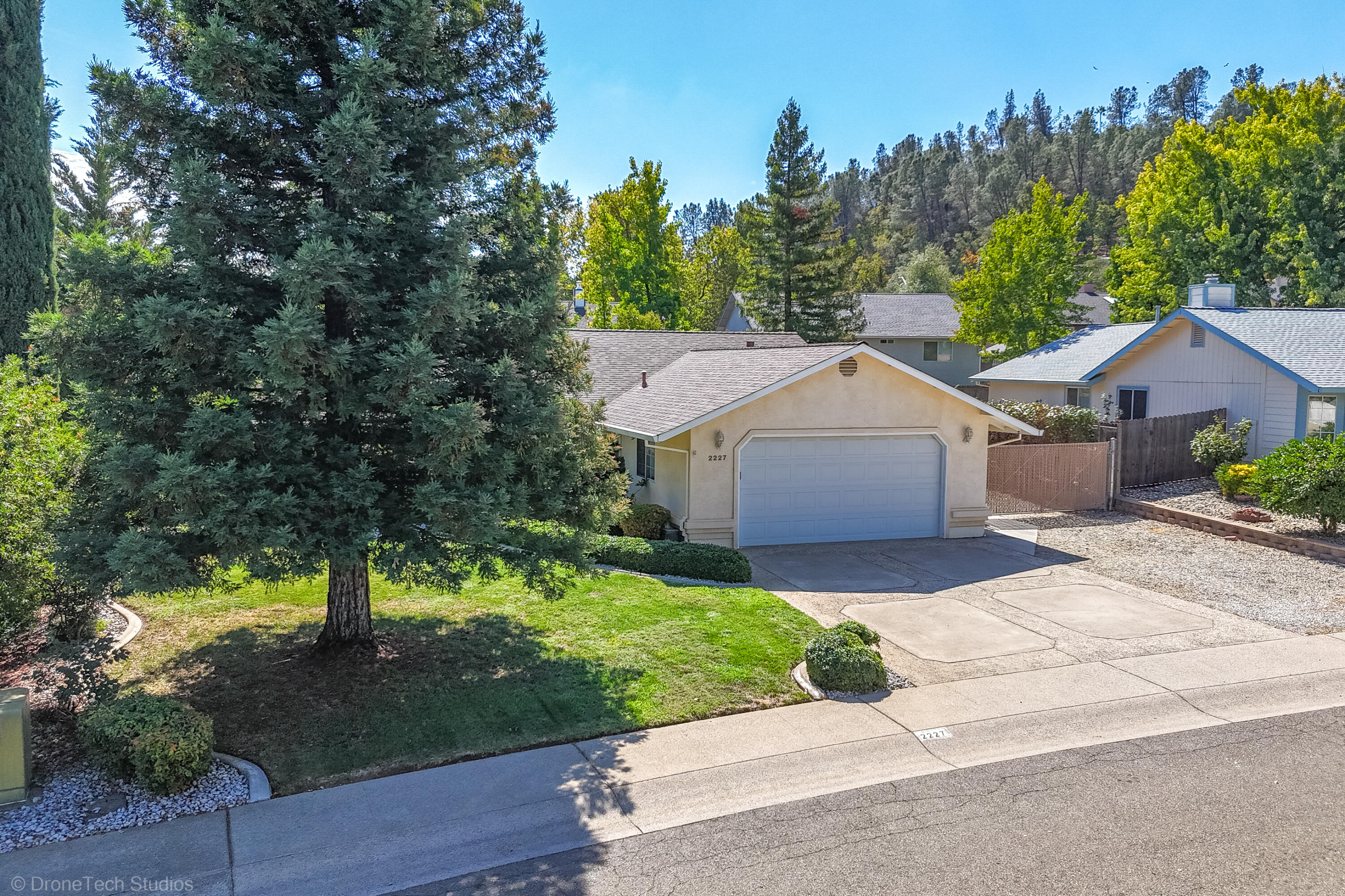 2227 Wicklow Street Redding, CA 96001 - Photo 73 of 90 a front view of a house with yard and green space