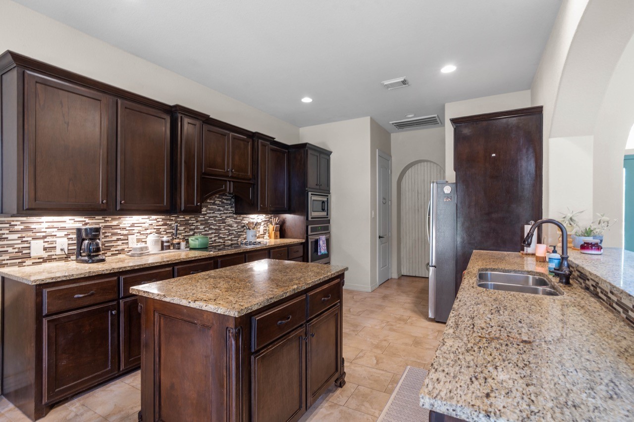 27585 Rio Blanco Drive Splendora, TX 77372 - Photo 11 of 39 More than one chef can cook in this kitchen! Extra cabinet space to help store kitchen and cooking utensils easily. Nice sized walk-in pantry is located behind the door on the left. Check out the lighting under the cabinets.