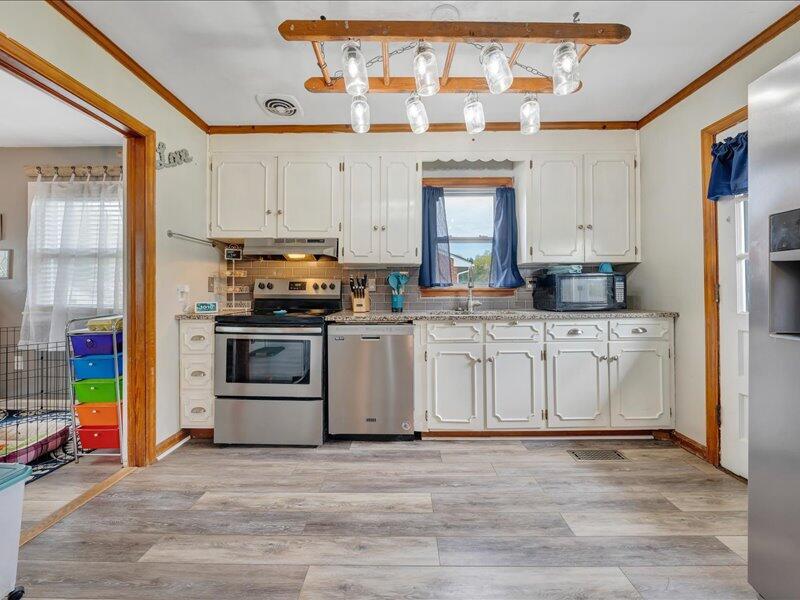 2015 Laura Road Northwest Roanoke, VA 24017 - Photo 12 of 32 a kitchen with stainless steel appliances a stove and white cabinets