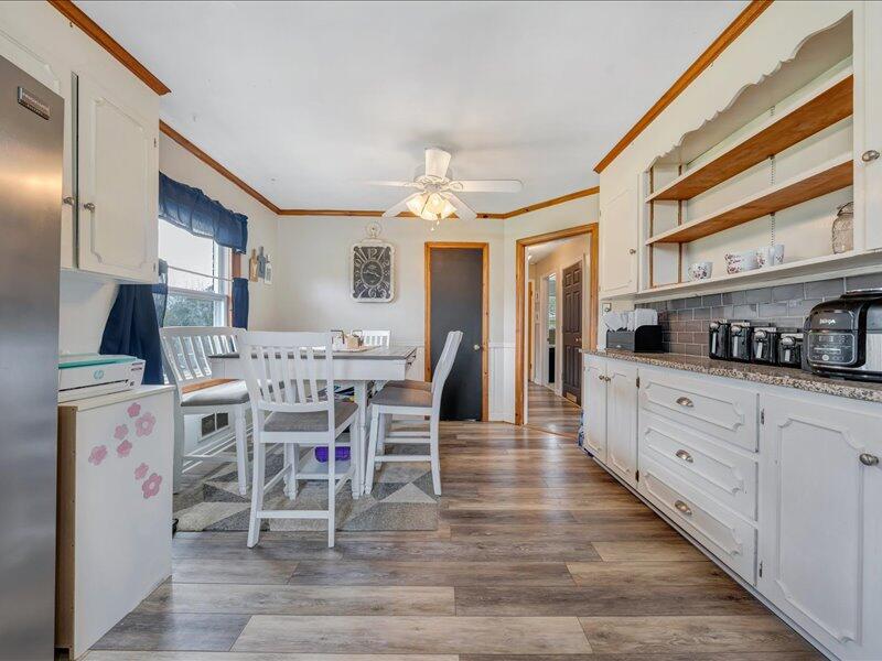 2015 Laura Road Northwest Roanoke, VA 24017 - Photo 14 of 32 a kitchen with stainless steel appliances kitchen island granite countertop a table chairs sink and cabinets