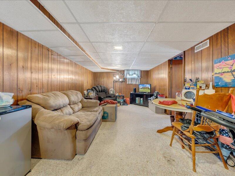 2015 Laura Road Northwest Roanoke, VA 24017 - Photo 20 of 32 a living room with furniture a rug and a projector
