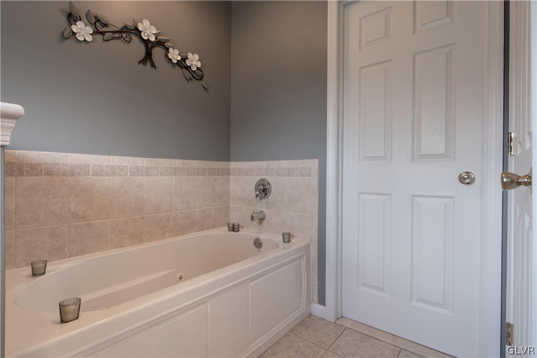 4142 Walter Road Bethlehem, PA 18020 - Photo 38 of 50 a white bath tub sitting next to a wooden vanity