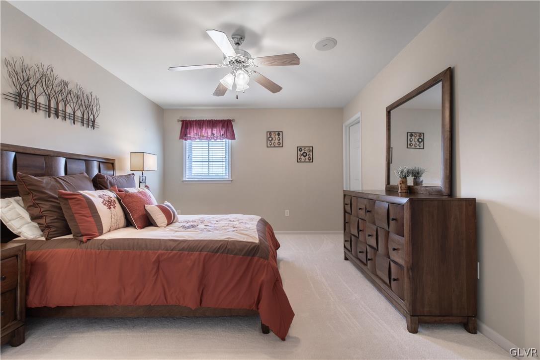 4142 Walter Road Bethlehem, PA 18020 - Photo 41 of 50 a bedroom with a bed and a chandelier