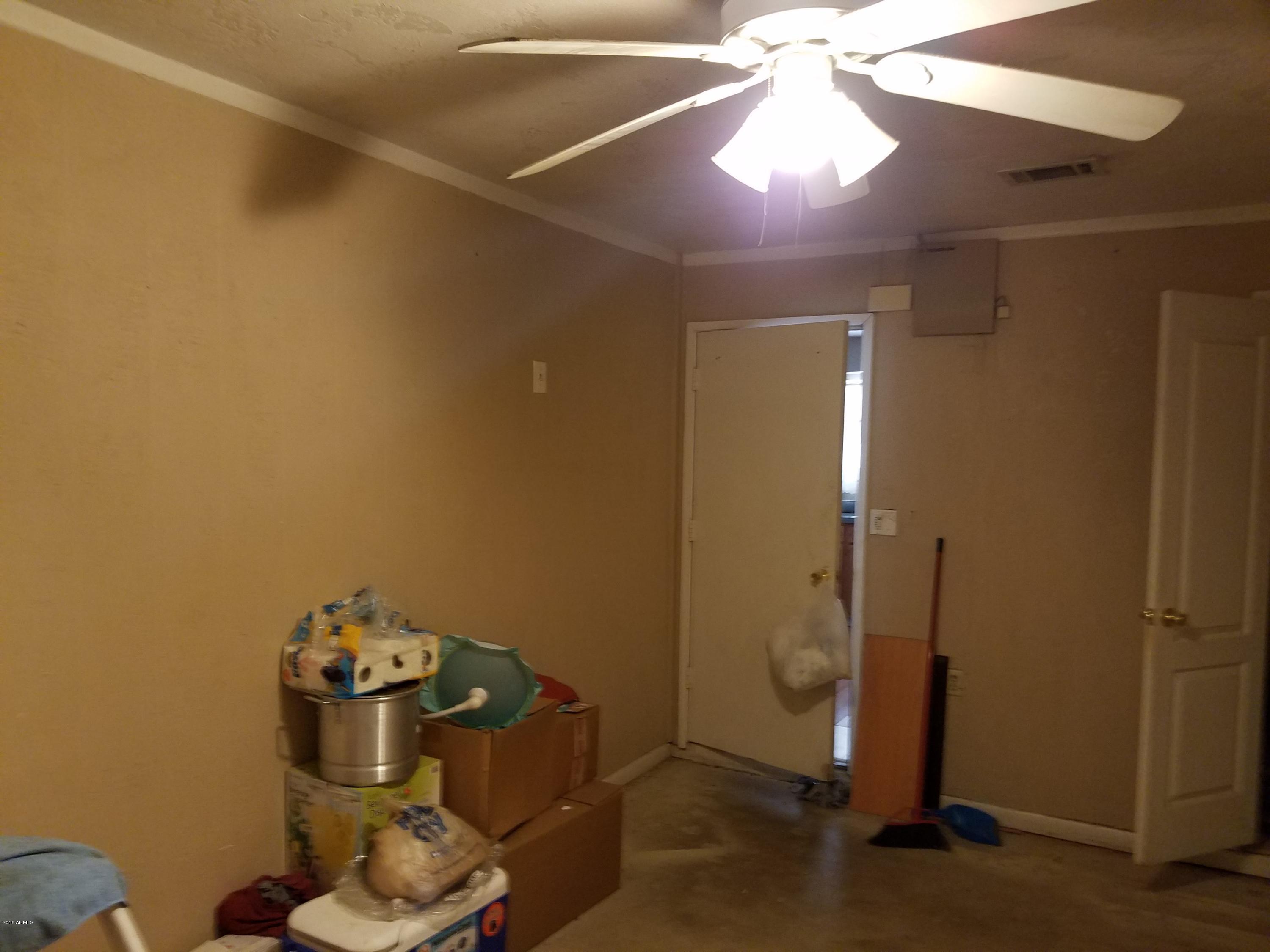 4939 West Berkeley Road Phoenix, AZ 85035 - Photo 16 of 60 a room with a mirror and a fan