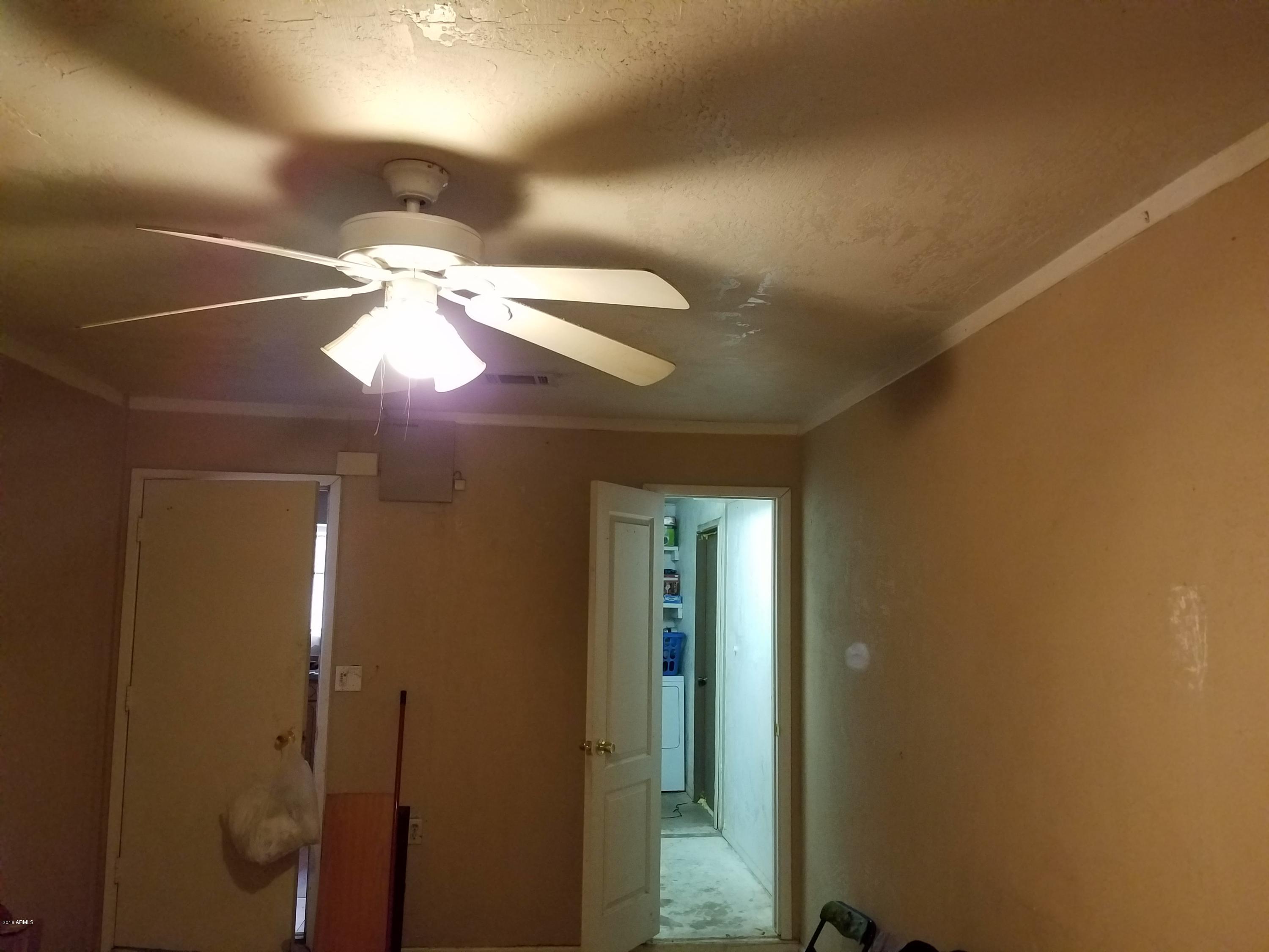 4939 West Berkeley Road Phoenix, AZ 85035 - Photo 19 of 60 a view of a room with a mirror and fan