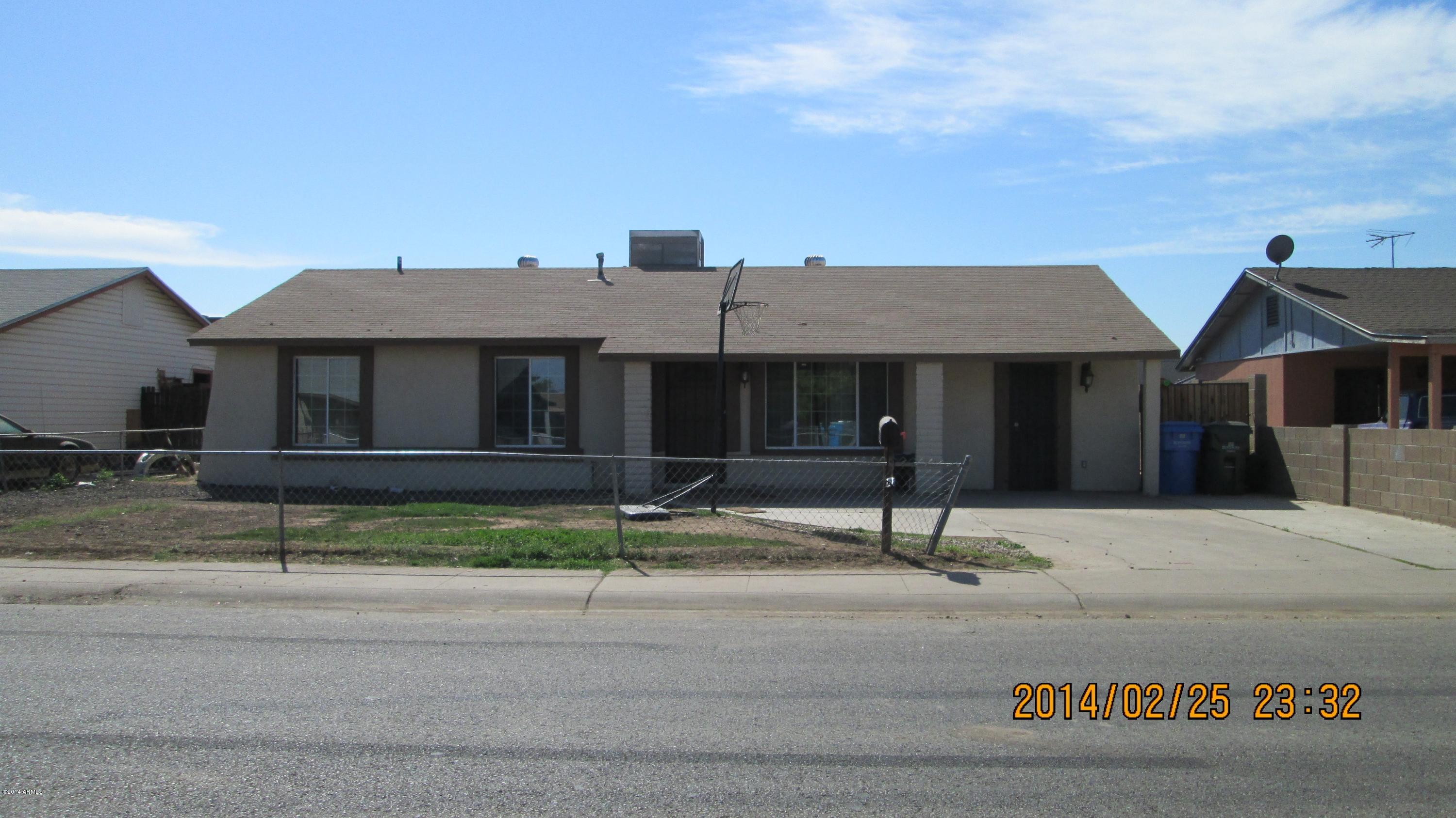 4939 West Berkeley Road Phoenix, AZ 85035 - Photo 2 of 60 a front view of a house with a garden