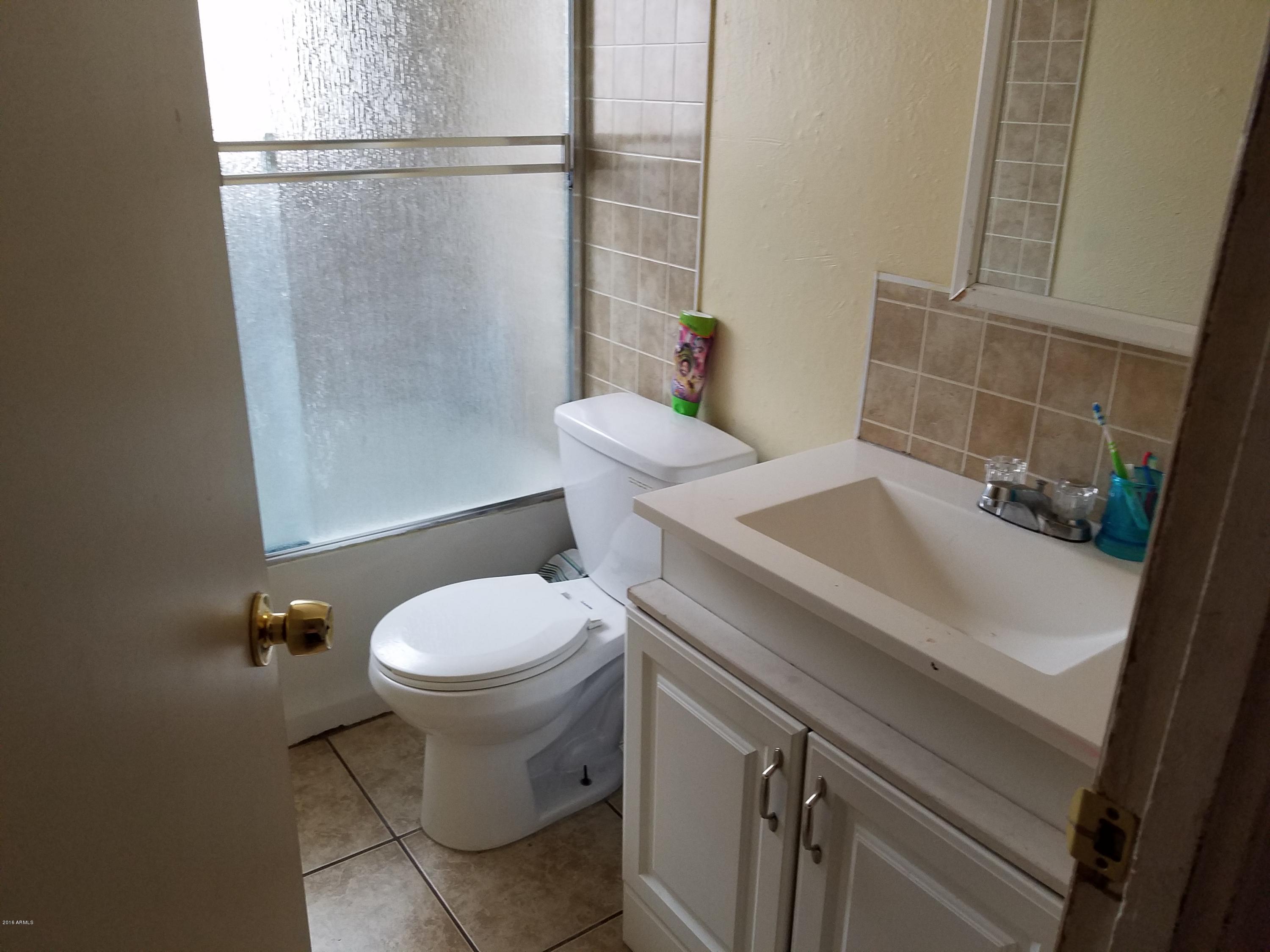 4939 West Berkeley Road Phoenix, AZ 85035 - Photo 31 of 60 a bathroom with a sink toilet and shower