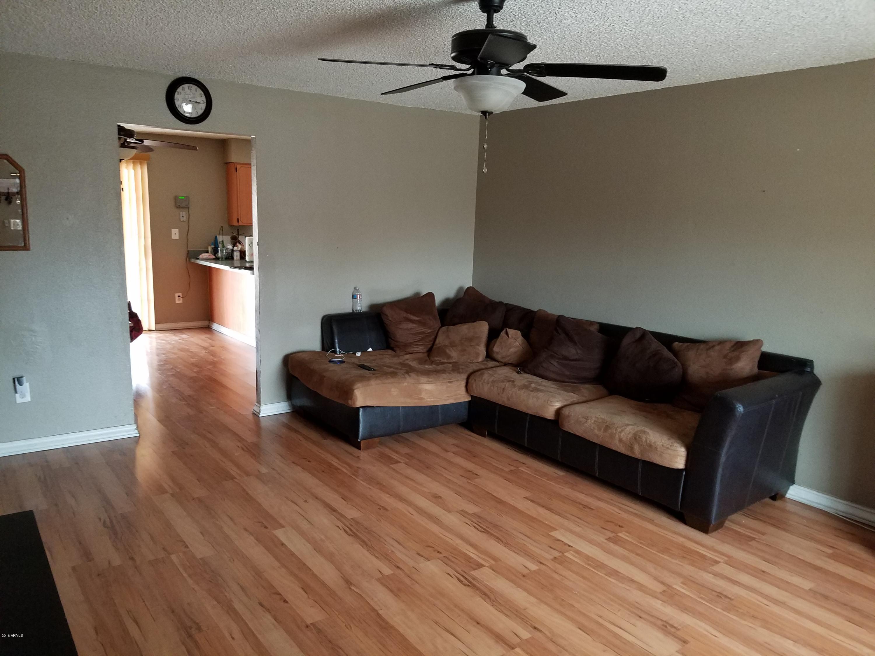 4939 West Berkeley Road Phoenix, AZ 85035 - Photo 52 of 60 a living room with furniture and a wooden floor