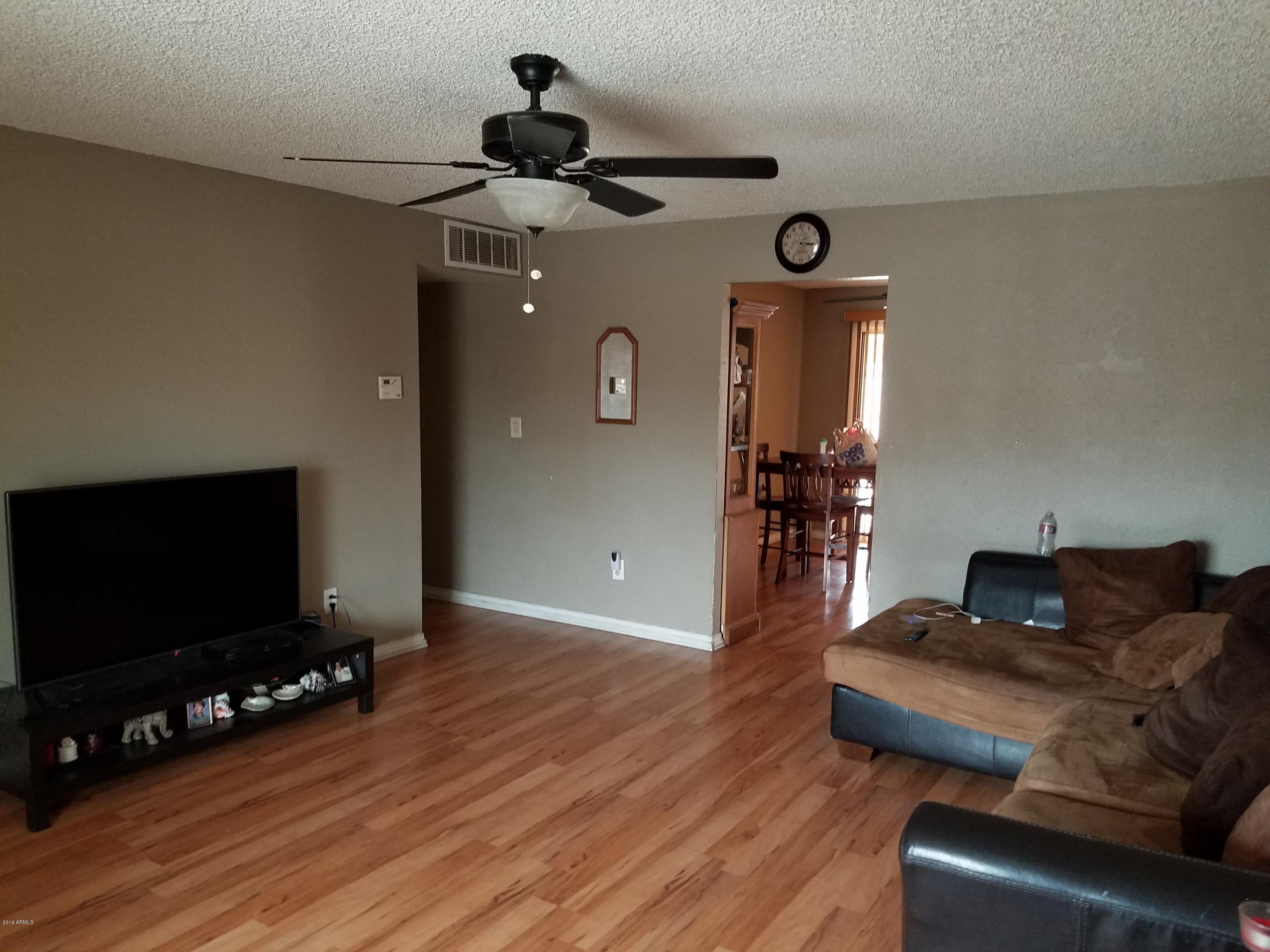 4939 West Berkeley Road Phoenix, AZ 85035 - Photo 53 of 60 a living room with furniture and a flat screen tv