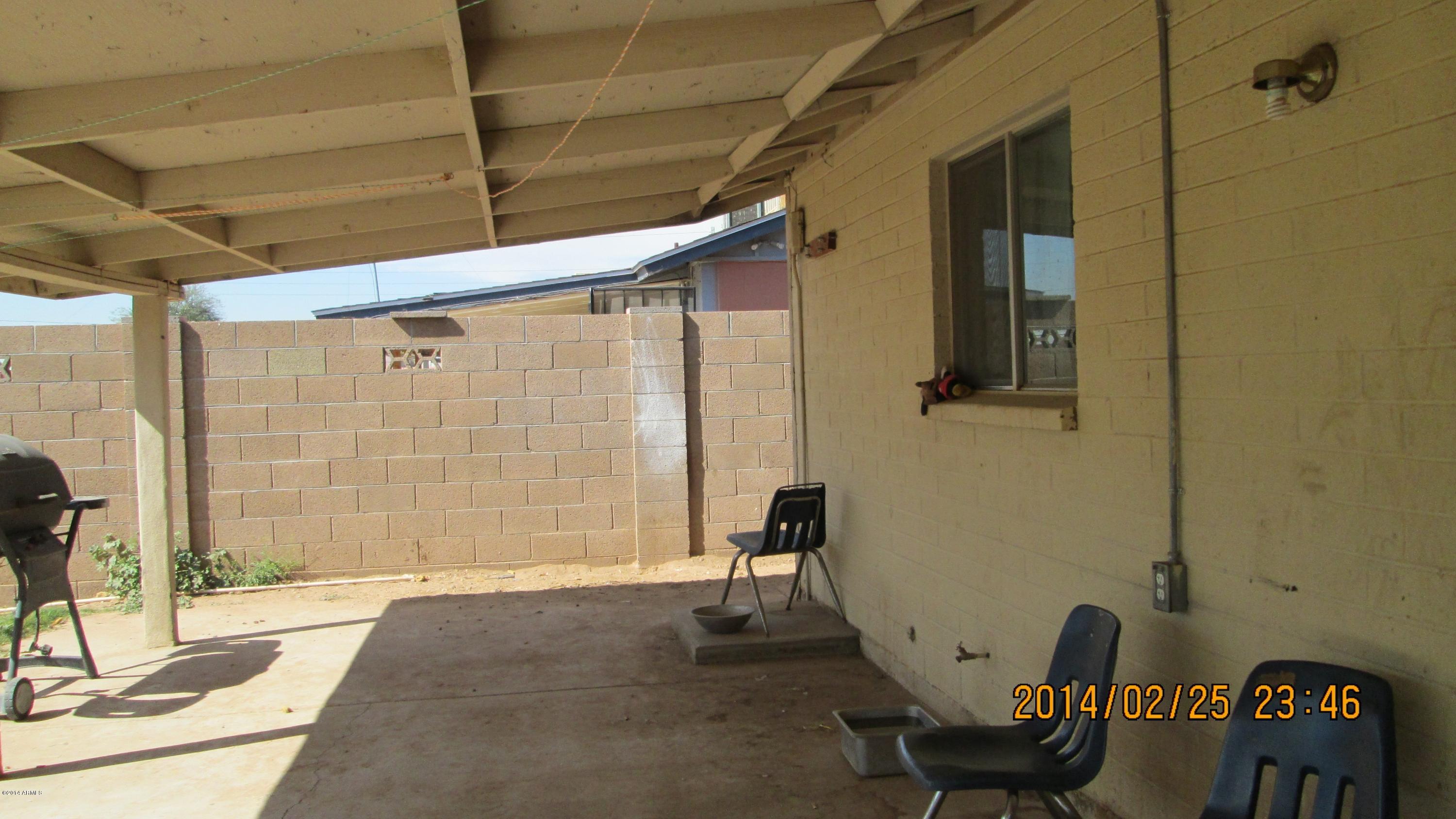 4939 West Berkeley Road Phoenix, AZ 85035 - Photo 6 of 60 a view of a door and chair in the patio