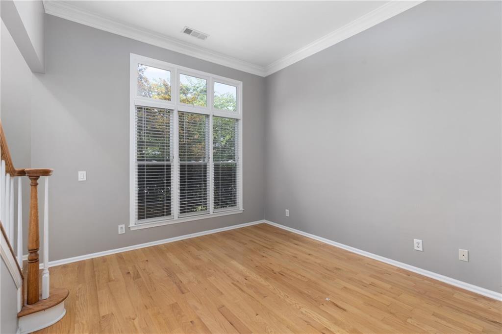 2631 East Madison Drive Atlanta, GA 30360 - Photo 11 of 66 a view of an empty room with wooden floor and a window