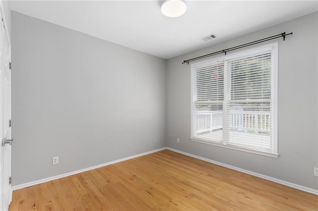 2631 East Madison Drive Atlanta, GA 30360 - Photo 13 of 66 a view of an empty room with wooden floor and a window