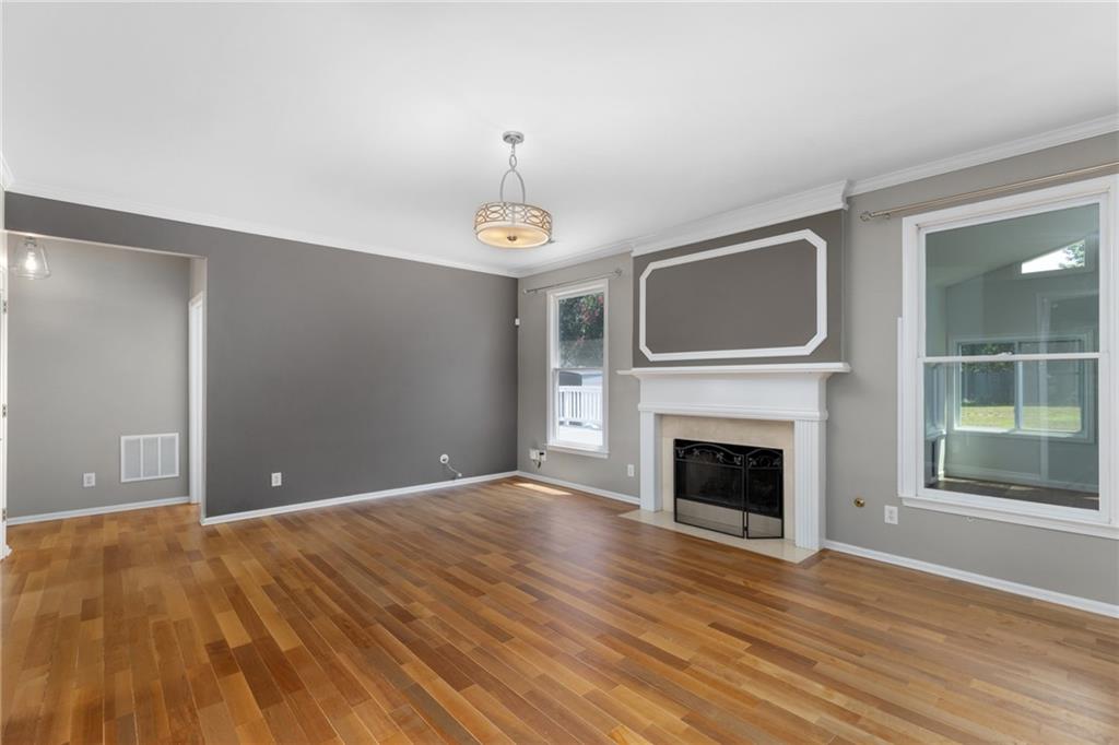 2631 East Madison Drive Atlanta, GA 30360 - Photo 19 of 66 a view of empty room with wooden floor and fireplace