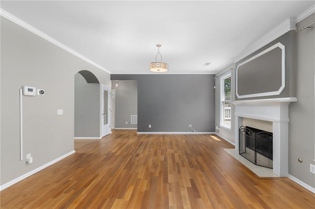2631 East Madison Drive Atlanta, GA 30360 - Photo 20 of 66 a view of empty room with wooden floor and fireplace