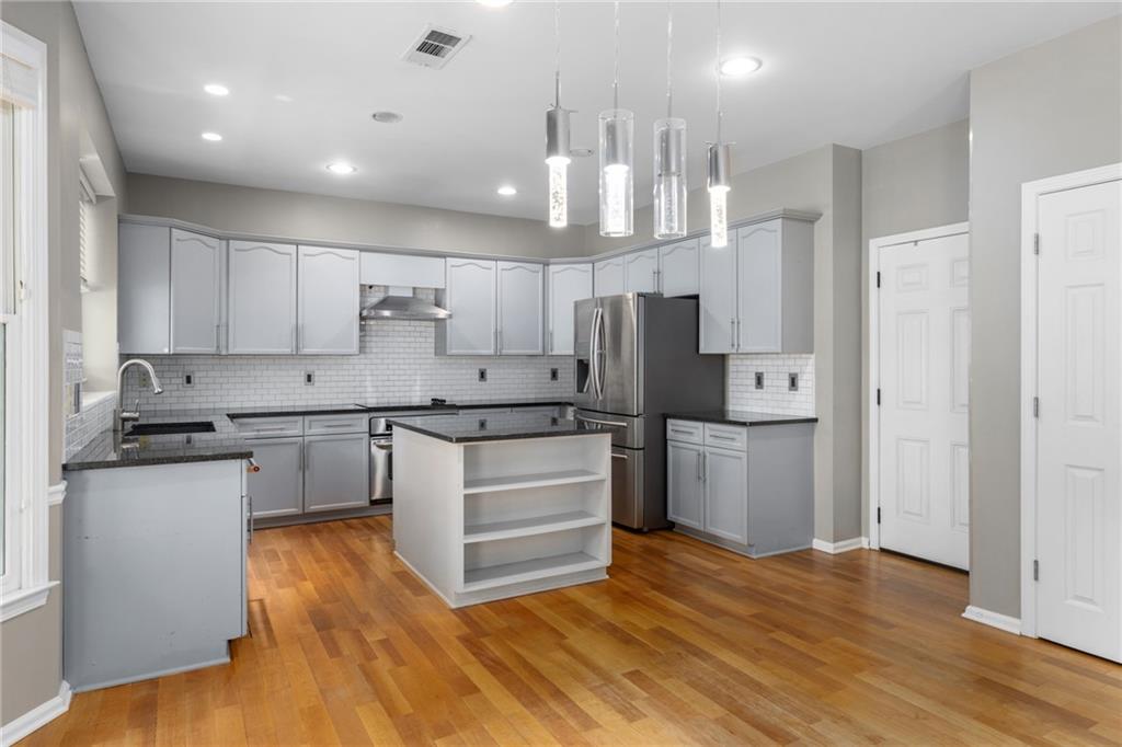 2631 East Madison Drive Atlanta, GA 30360 - Photo 23 of 66 a large kitchen with stainless steel appliances a refrigerator and a stove top oven