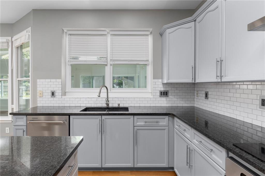 2631 East Madison Drive Atlanta, GA 30360 - Photo 26 of 66 a kitchen with granite countertop a sink and a stove