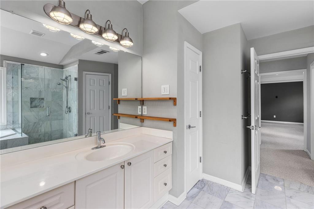 2631 East Madison Drive Atlanta, GA 30360 - Photo 42 of 66 a bathroom with a shower sink double and mirror