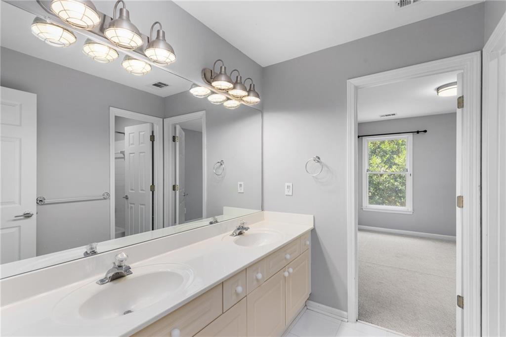 2631 East Madison Drive Atlanta, GA 30360 - Photo 45 of 66 a bathroom with a double vanity sink and a mirror