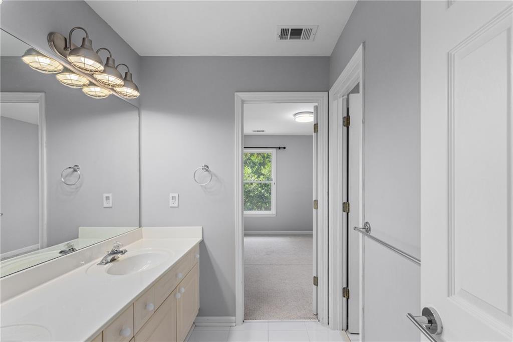 2631 East Madison Drive Atlanta, GA 30360 - Photo 46 of 66 a spacious bathroom with a tub a mirror and a sink