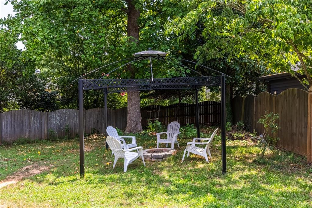 2631 East Madison Drive Atlanta, GA 30360 - Photo 60 of 66 a view of backyard with table and chairs and potted plants