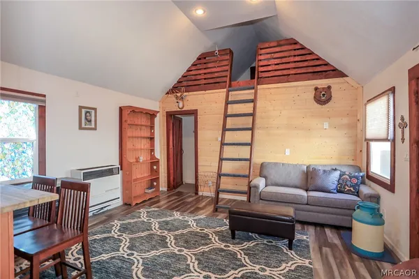 a bedroom with furniture and a rug
