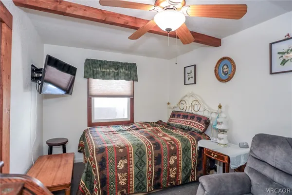a bedroom with a bed and a chair