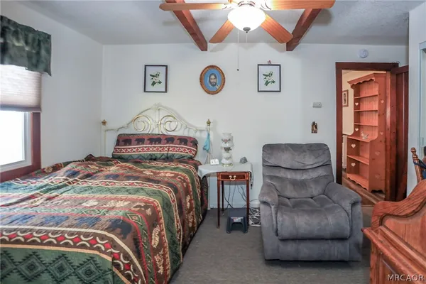 a bedroom with a bed and window