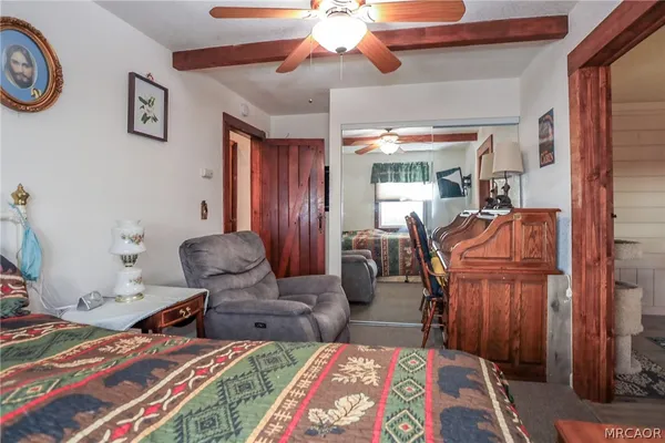 a bedroom with furniture and a chandelier