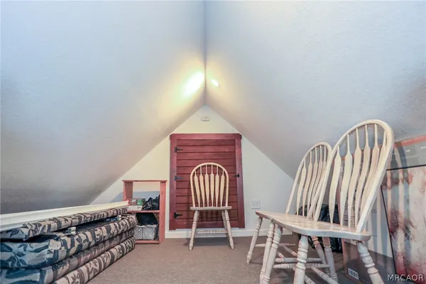 a bedroom with a bed and a chair