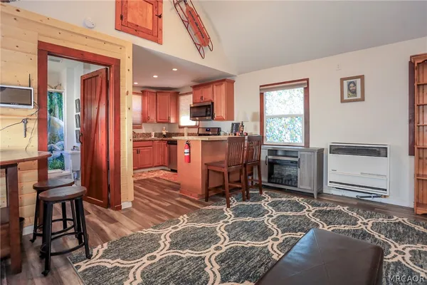 a kitchen with stainless steel appliances granite countertop sink stove top oven and cabinets