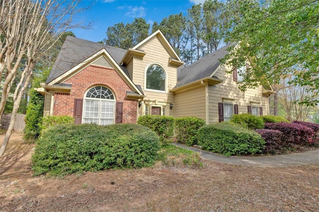 19 Wesley Court Acworth, GA 30101 - Photo 1 of 1 a view of a brick house with large windows and a yard