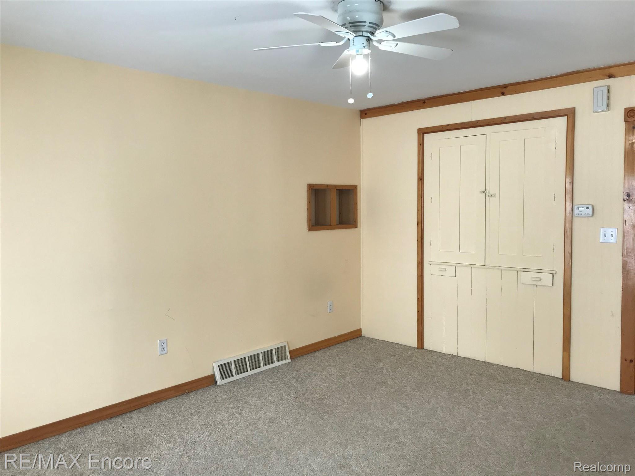 7352 Peet Road Chesaning, MI 48616 - Photo 21 of 50 Living Room continued. Note original cabinets and built ins.